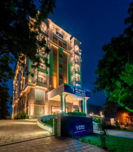 a building with a sign in front of it at night at Regenta Central Herald Mysore in Mysore