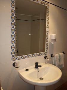 a bathroom with a sink and a mirror at El Churrón in Larrés