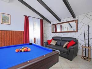 a living room with a pool table and a couch at Villa Nova in Vela Luka