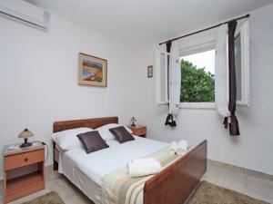 a bedroom with a large bed and a window at Villa Nova in Vela Luka +34 photos