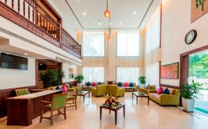 a lobby with couches and chairs in a building at Regenta Central Herald Mysore in Mysore