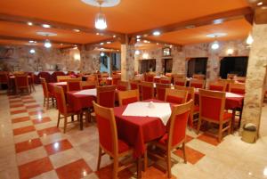 a dining room with red tables and chairs at Al Rashid Hotel in Wadi Musa