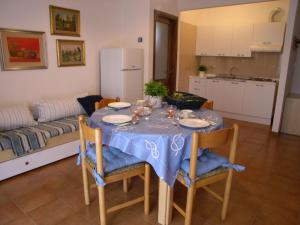 a table with a blue table cloth on it in a living room at Condominio Alto Adriatico in Grado