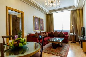 a living room with a red couch and a table at Lahoya Garden in Beirut