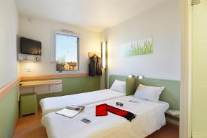 Postel nebo postele na pokoji v ubytování First Inn Hotel