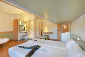 Postel nebo postele na pokoji v ubytování First Inn Hotel