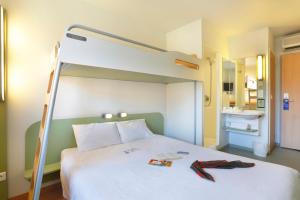 Postel nebo postele na pokoji v ubytování First Inn Hotel