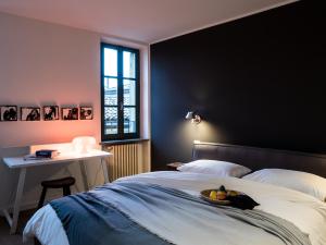 a bedroom with a bed with a bowl of fruit on it at Le Logge in Parma