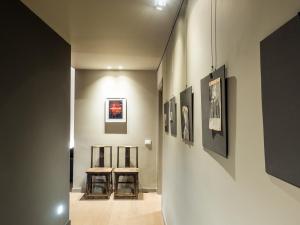 a hallway with paintings on the walls of a museum at Le Logge in Parma