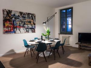a dining room with a table and chairs at Le Logge in Parma
