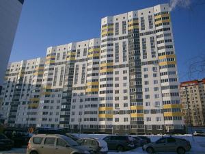 スィクティフカルにあるComfort Apartments Timanの駐車場車を停めた大きな建物