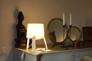 uma mesa com um candeeiro e dois espelhos em Virginias B&B em Savona