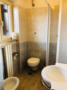a bathroom with a toilet and a sink at Hotel Casarola - Trigoria in Castel di Decima