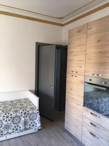 ブルコリにあるLa Casa Accanto il Castelloのベッドルーム1室(ベッド1台、ドレッサー、クローゼット付)