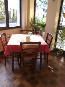 a dining room table with a red table cloth on it at Il Vapore in Oggebbio