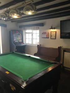 a room with a pool table and a couch at The Old Malt Scoop Inn in Lapford