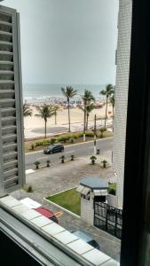 vista sulla spiaggia da una finestra di un edificio di Edificio Edmeia a Praia Grande