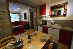a kitchen with a wooden table and a kitchen with a dining room at Chalet Champraz - Free Parking in Chamonix