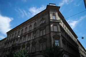 a building with a clock tower on top of it at Barcsay Apartment in Budapest