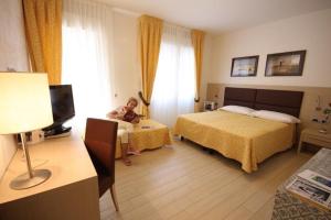 Ένα ή περισσότερα κρεβάτια σε δωμάτιο στο Hotel La Pergola di Venezia