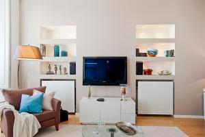 a living room with a couch and a tv at Libest Chiado 3 - Largo do Picadeiro in Lisbon
