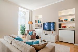 a living room with a couch and a tv at Libest Chiado 3 - Largo do Picadeiro in Lisbon