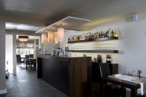 a restaurant with a bar with bottles on the wall at Hotel - Restaurant Lakerhof in Ohé en Laak