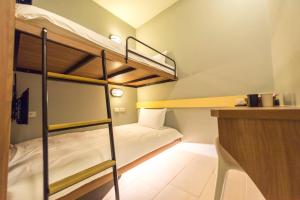 Postel nebo postele na pokoji v ubytování Divecube Hotel