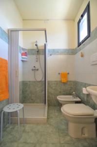 y baño con ducha, aseo y lavamanos. en Residence Oasi Salento, en Torre dell'Orso
