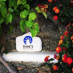 a sign that says hereresrescue next to flowers at Irene's Residence in Mikonos