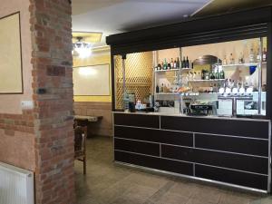 a bar in a restaurant with a brick wall at Domino in Berehove