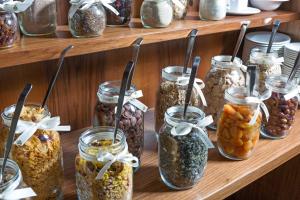 a bunch of jars of nuts and seeds on a shelf at Hotel Kaiserhof Wien in Vienna