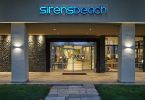 a entrance to a store with a sign on the door at Sirens Beach & Village in Malia