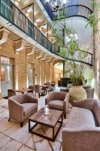 a lobby with couches and chairs and a table at 66 Saint Paul's & Spa in Valletta