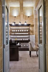 a dining room with a piano and a chair at 66 Saint Paul's & Spa in Valletta