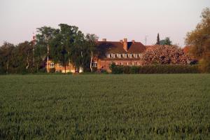 a large house in front of a field of grass at Hotel Lolland in Nørreballe