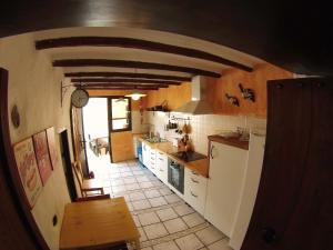 a large kitchen with a archway in a house at Luana House in Teguise