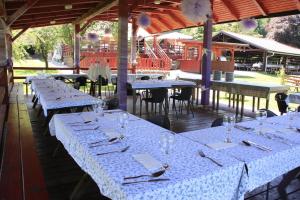 a row of tables with wine glasses and napkins at B&B Pri Peclju in Podgrad