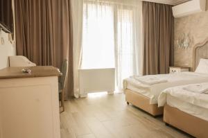una camera d'albergo con due letti e una finestra di Residence Bilyana a Svilengrad