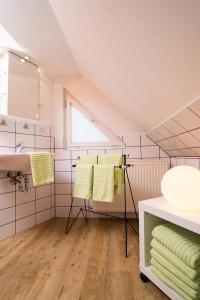 a bathroom with yellow towels and a sink at Thomasmühle Ferienwohnungen in Leutershausen