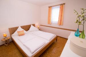a bedroom with a bed and a sink in it at Thomasmühle Ferienwohnungen in Leutershausen