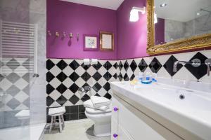 a bathroom with a sink and a toilet and a mirror at Friendly Rentals Olimpic Beach in Barcelona