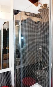 a shower with a glass door in a bathroom at altana san marco in Venice +6 photos