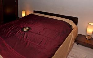a bed with a red comforter in a room at altana san marco in Venice
