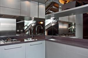 a kitchen with white cabinets and stainless steel appliances at altana san marco in Venice