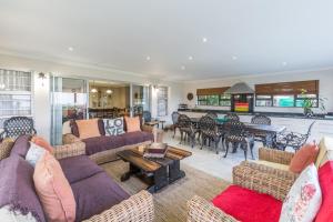 a large living room with couches and a table at Oceanview B&B in East London