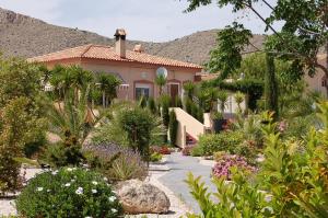 a house with a garden in front of it at Finca Vista Valle in Hondón de las Nieves