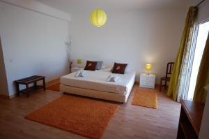a bedroom with a bed and two rugs at Casa da Eira - Private Villa - pool - Free wi-fi - Air Con in Silves +25 photos