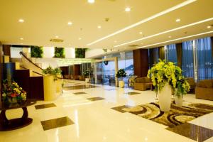 a lobby with flowers and plants in a building at River Hotel in Hà Tiên +174 photos