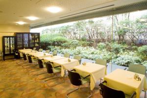 a conference room with tables and chairs and a large window at Tokyo Grand Hotel in Tokyo